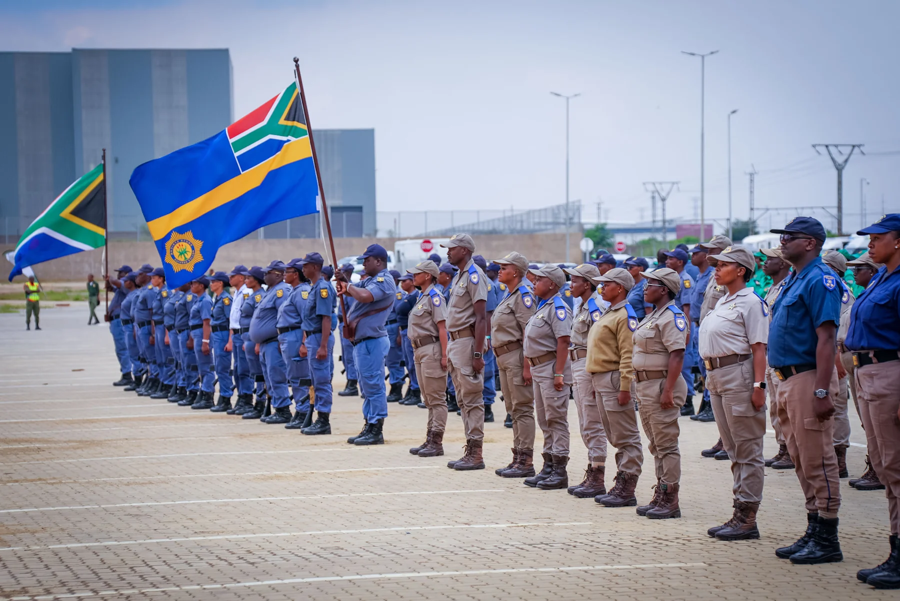 Officers standing in formation with flags
