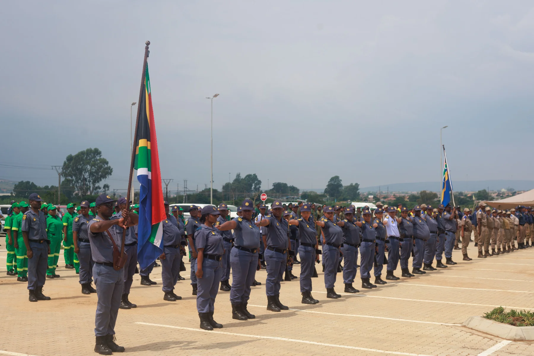 Officers marching with ceremonial flags